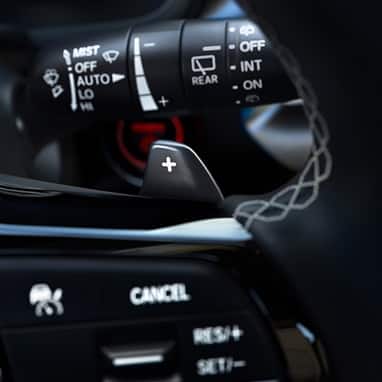 2027 Honda Civic Hatchback Sport Touring Hybrid close up of the steering wheel paddle shifters (Compact Hatchback).